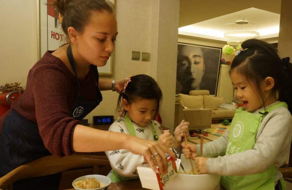 An art teacher helping their students