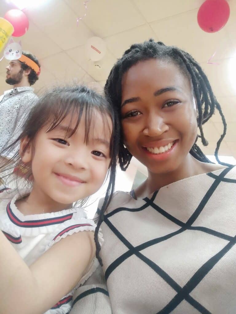 Teacher Nomie and a student