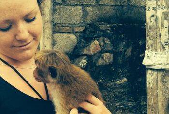 Lizzie Gayton holding a macaque monkey in Sri Lanka