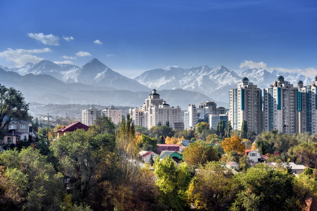 City landscape of Almaty on a background of snow-capped mountains